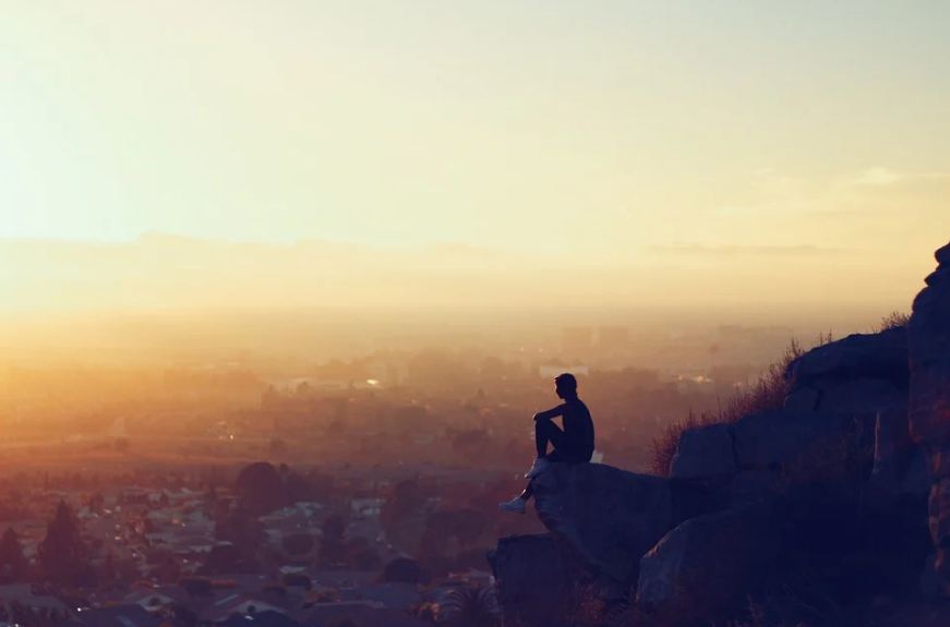 man-sitting-cliffs-viewpoint
