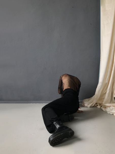 man-in-black-pants-and-black-leather-shoes-lying-on-bed