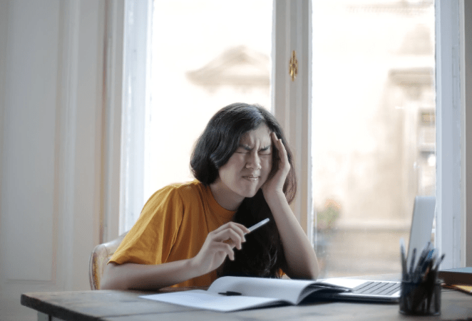female-student-suffering-from-headache-at-home