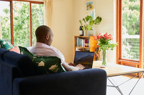 A man working with back support offered by a gel infused cushion