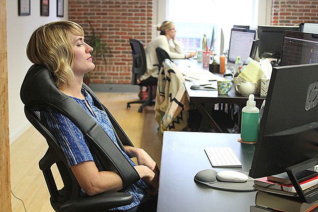 Back massager being used in office