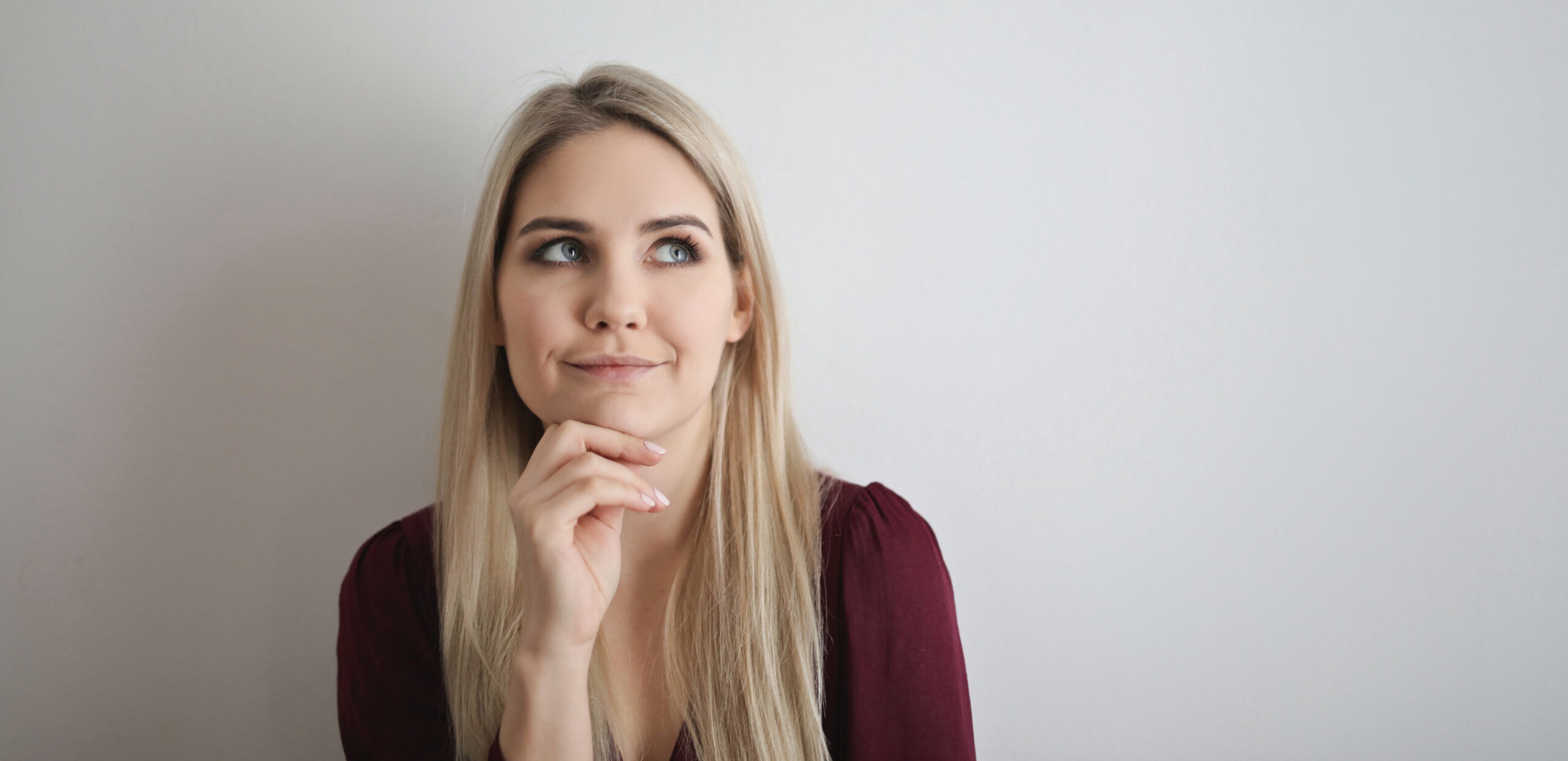 A woman smiling while thinking