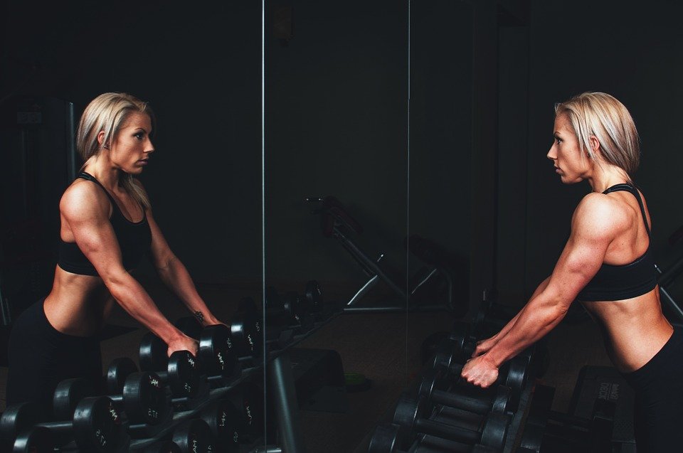 woman working out looking at the mirror