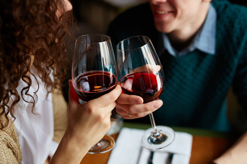 Couple toasting with red wine in restaurant