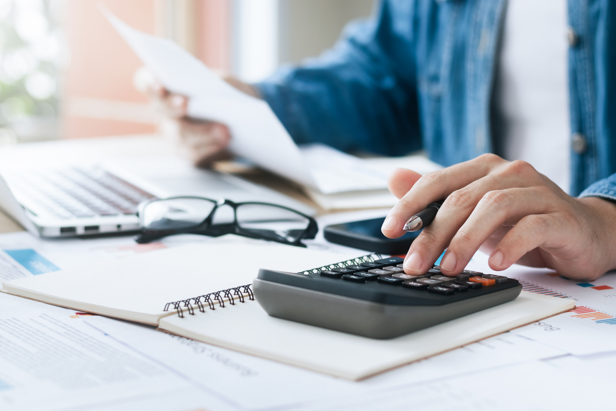Investors are calculating profits and costs with calculators, growth and investment chart analysis, business planning and strategies to maximize sales profits. Long term business plan