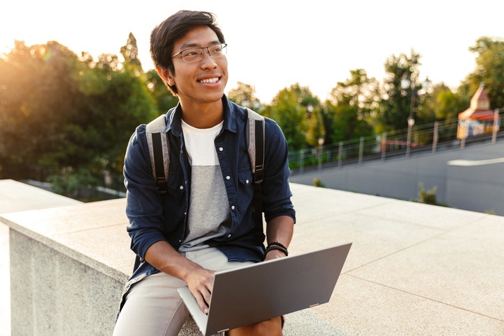 Happy asian man student with backpack