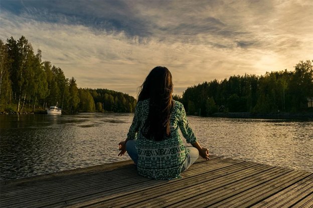 woman relaxing by the lake with a great view