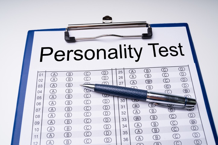 Personality Test Sheet And Pen With Clipboard Over Table