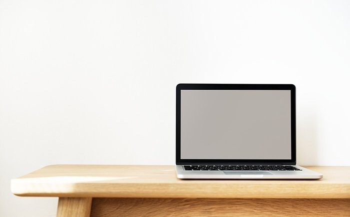 a laptop on a wooden desk