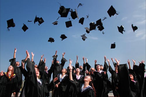 College graduates throwing their caps in the air