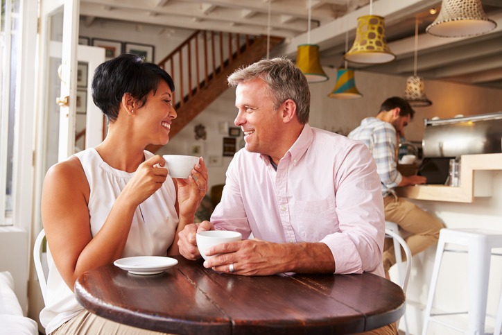 Middle aged couple in a cafe enjoying a coffee