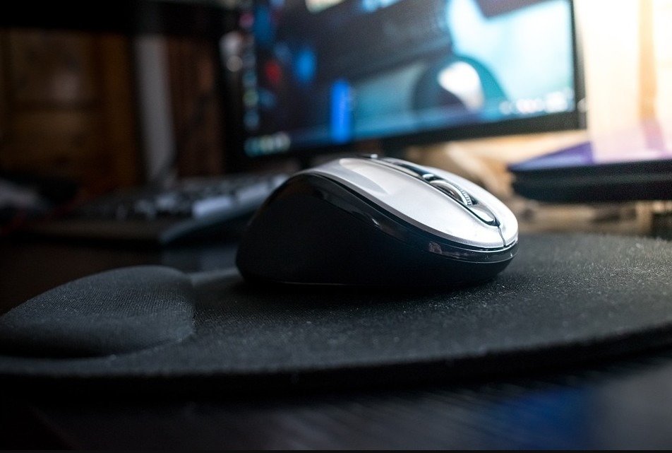 Black mouse on top of an ergonomic mouse pad
