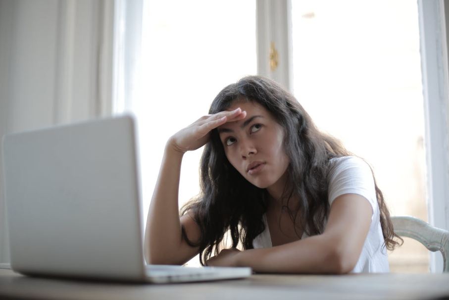 young-annoyed-female-freelancer-using-laptop-at-home