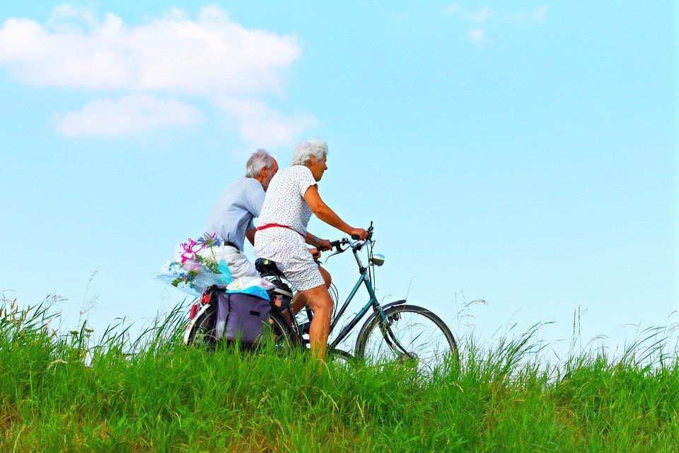 elderly couple riding bicycles