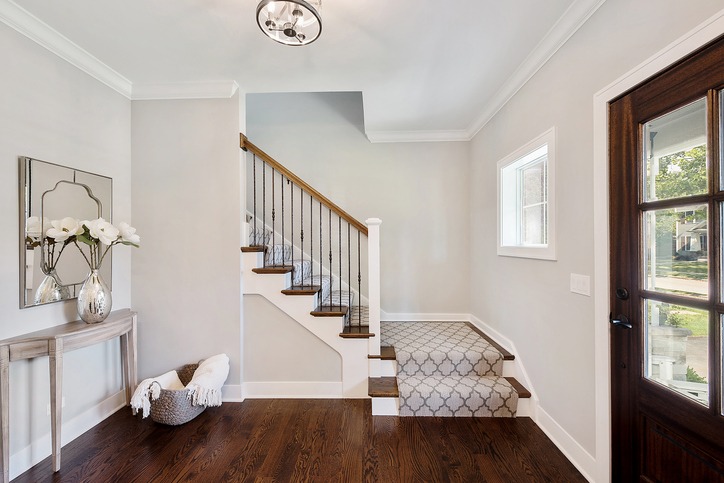 Front entryway with partially carpeted stairs