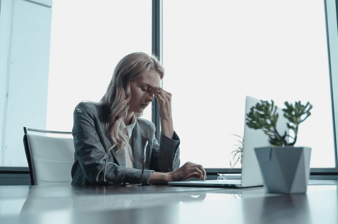 a depressed woman sitting in the office