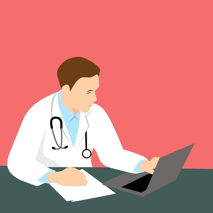 A physician checking symptoms on a report