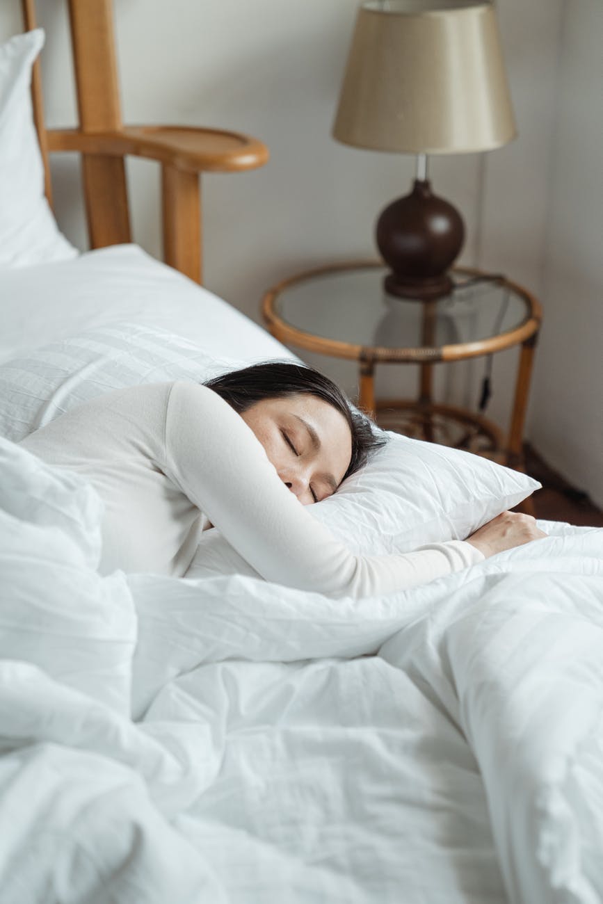 A woman sleeping soundly on a memory foam mattress. 